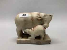 An 18th/ early 19th century Asian carved marble figure of a cow and calf with two female attendants,