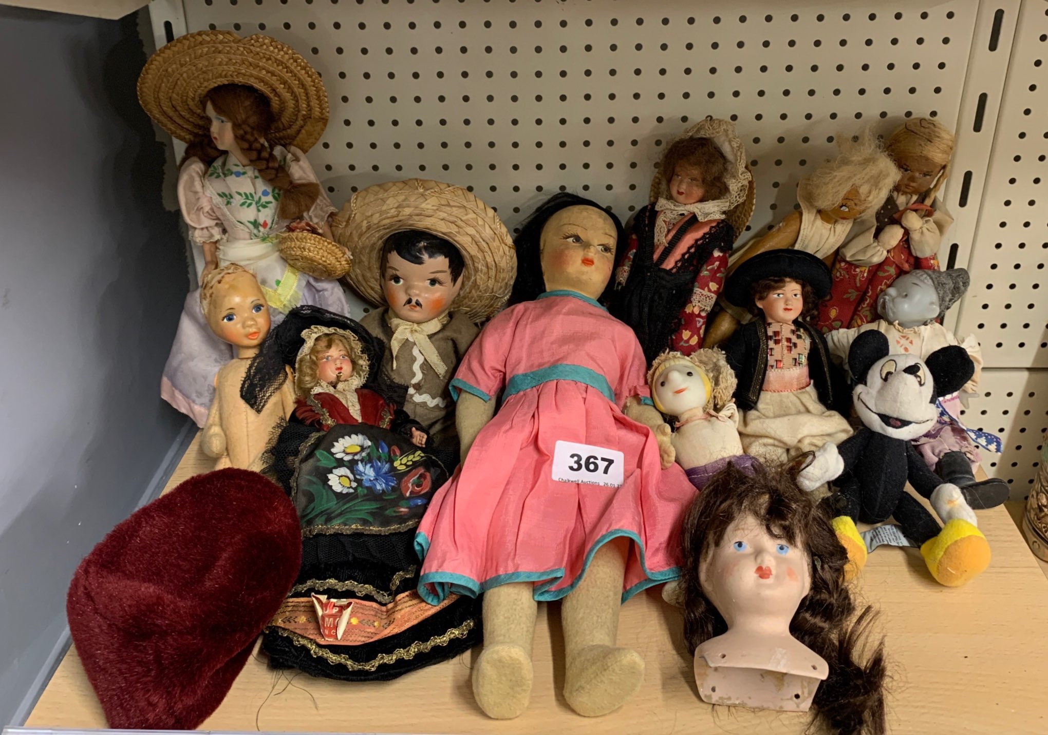 A group of vintage dolls and toys.