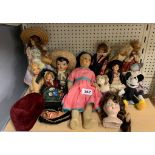 A group of vintage dolls and toys.