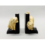 A pair of 1920's painted ceramic 'hide and seek' bookends, H. 12cm.