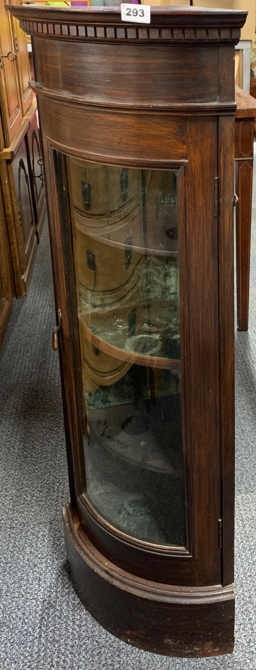 A glazed mahogany corner cabinet, W. 44cm. H. 102cm.