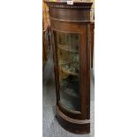 A glazed mahogany corner cabinet, W. 44cm. H. 102cm.