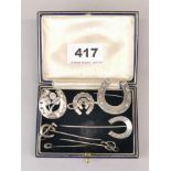 A group of mixed antique silver horse shoe brooches.