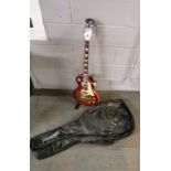 An electric guitar and case with stand.