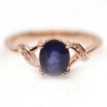 A 925 silver rose gold gilt ring set with an oval cut sapphire, (P).