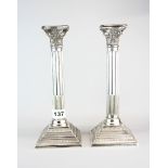 A pair of hallmarked silver Corinthian column candlesticks, H. 26cm.
