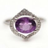 A 925 silver ring set with oval cut amethysts and white stones, (N).