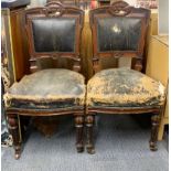 A pair of 19th century leather upholstered stained oak reading chairs from the British library