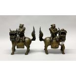A superb pair of 18th/ early 19th century Sino-Tibetan bronze liondog incense holders, H. 25cm.