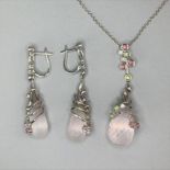 An 18ct white gold briolette cut rose quartz pendant set with peridot, topaz and diamonds on an 18ct