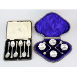 A set of six silver plated tea spoons with a hallmarked silver salt set.