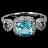 A matching 925 silver ring set with oval cut blue topaz and white stones, (N).