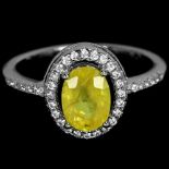 A 925 silver ring set with a fancy yellow sapphire and white stones, (O).