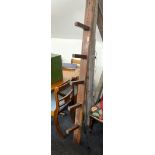 An antique pine saddle rack, L. 181cm, D. 26cm.