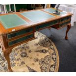 An impressive reproduction leather topped carved light mahogany double sided desk, 78 x 168cm.