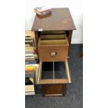 A 1920's oak record cabinet, 48 x 60 x 76cm, with unusual pull out drawer support.