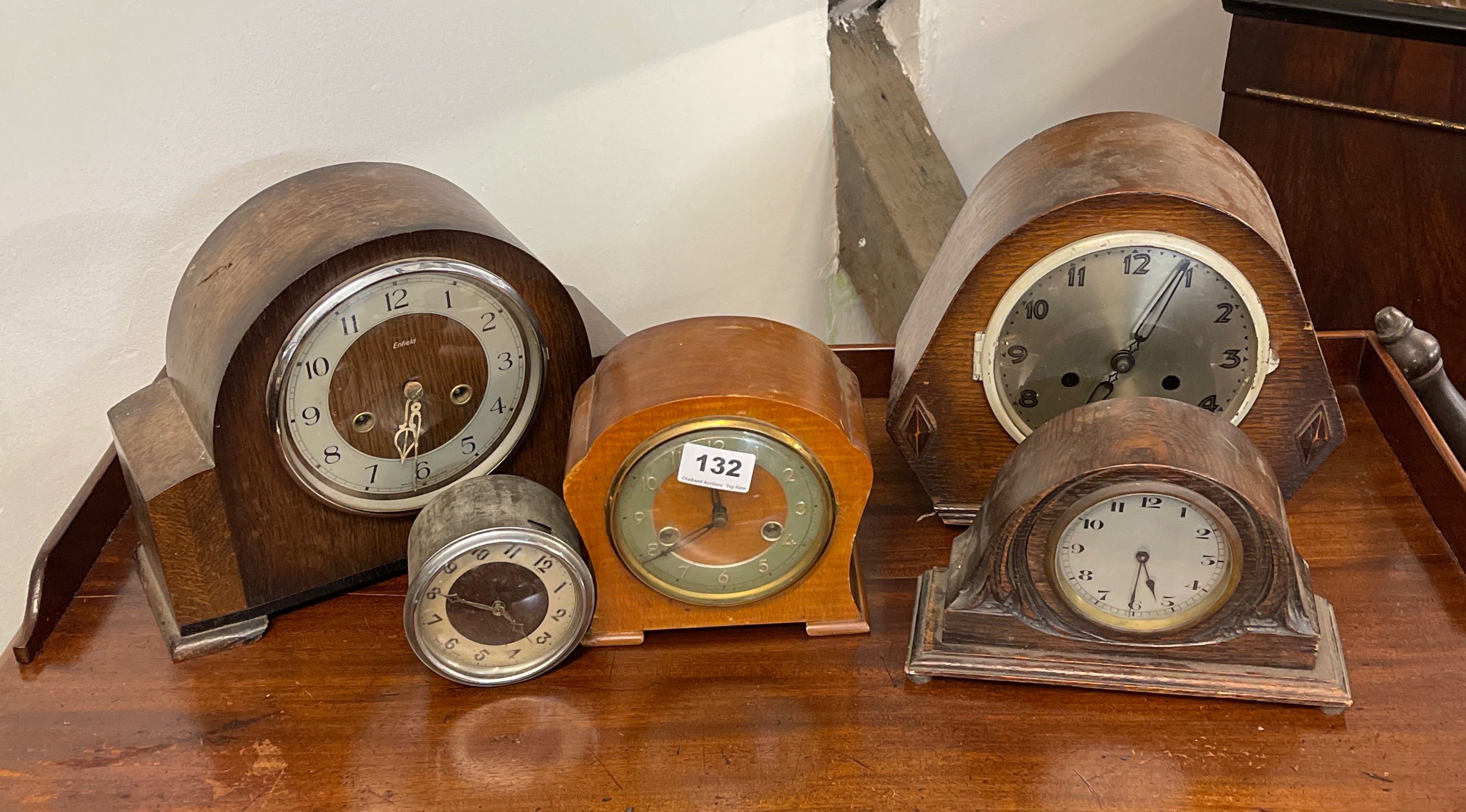 A group of five mixed clocks.