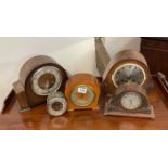 A group of five mixed clocks.