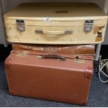 A tin trunk and two items of vintage luggage.