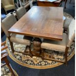 A 1930's Draw-leaf table and four upholstered chairs.