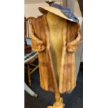A vintage fox fur cape with a ladies vintage sunhat. (mannequin not included).