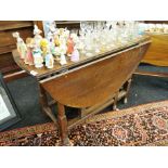 A 17th/early 18th century oak drop leaf dining table, W.36cm, opening to 127cm.