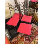 A set of four wrought iron chairs.
