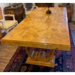 An Art Deco style birds-eye maple veneered pedestal dining table, 100 x 200cm.