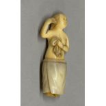 An amusing carved hippo tooth figure of a young woman with a removal towel, H. 6.2cm.