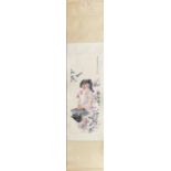 A Chinese ink and watercolour on silk and paper scroll of a girl sniffing a flower, understood to be