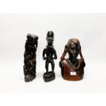 Three African carved ebony figures, tallest H. 35cm.