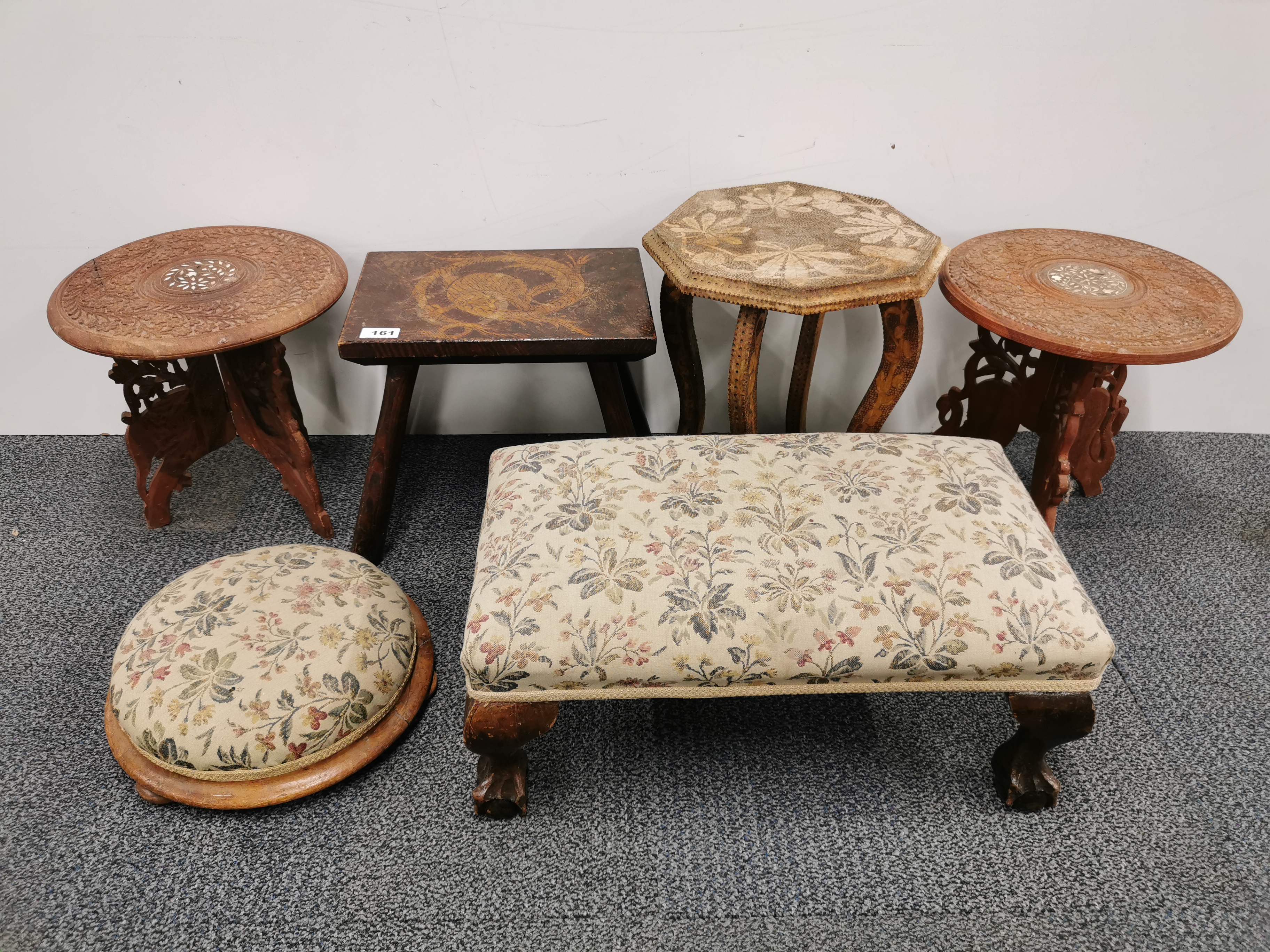 A group of small tables and footstools.
