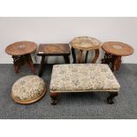 A group of small tables and footstools.