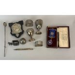 A box of mixed silver and white metal items.