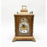 An oak cased moon phase bracket clock by Huis Buysse, H. 30cm. One finial detached but present.