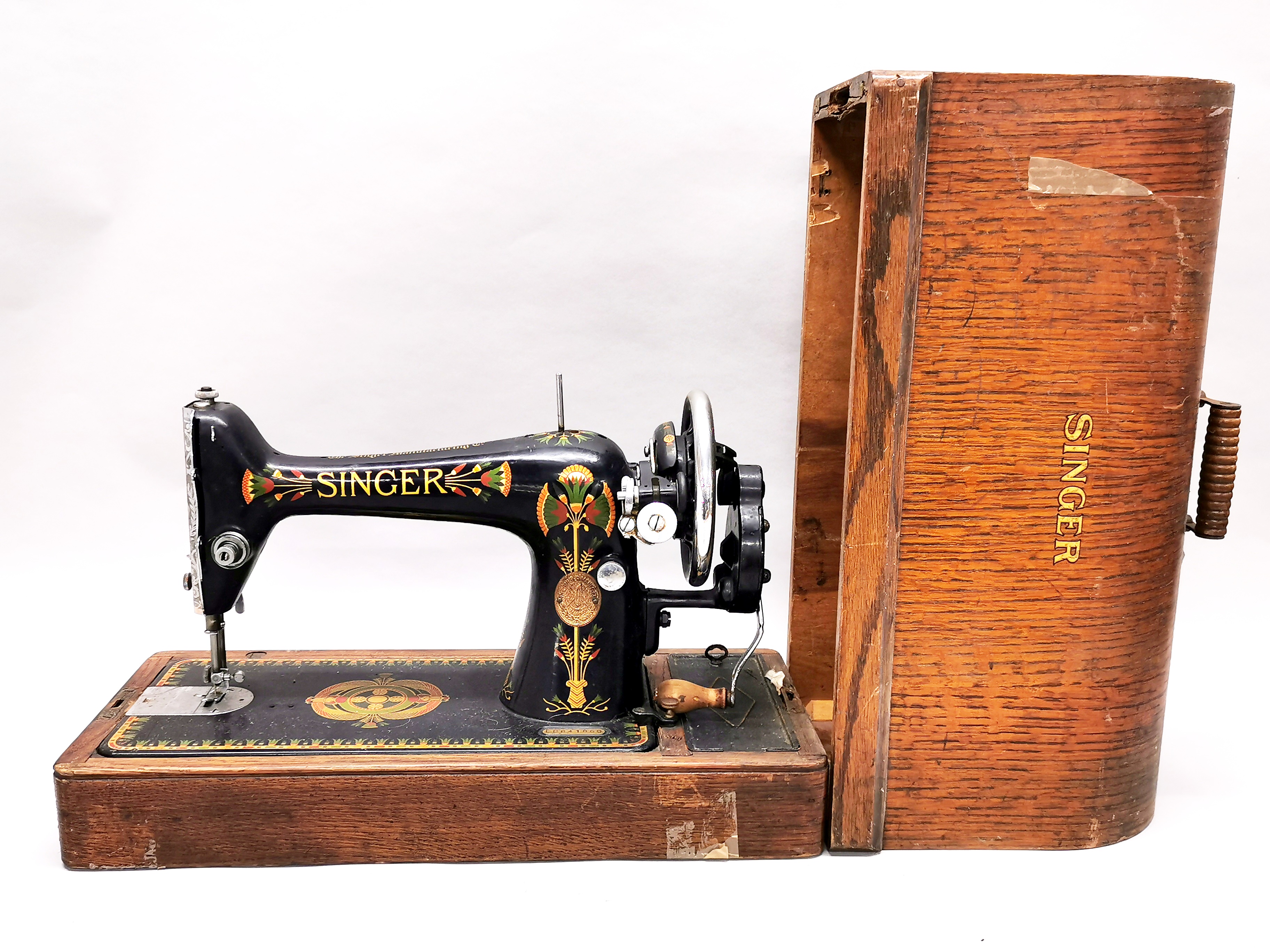 A cased early Singer sewing machine.