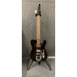 A black Thinline Telecaster style electric guitar with stand.