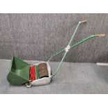 A vintage Ransomes push lawn mower.