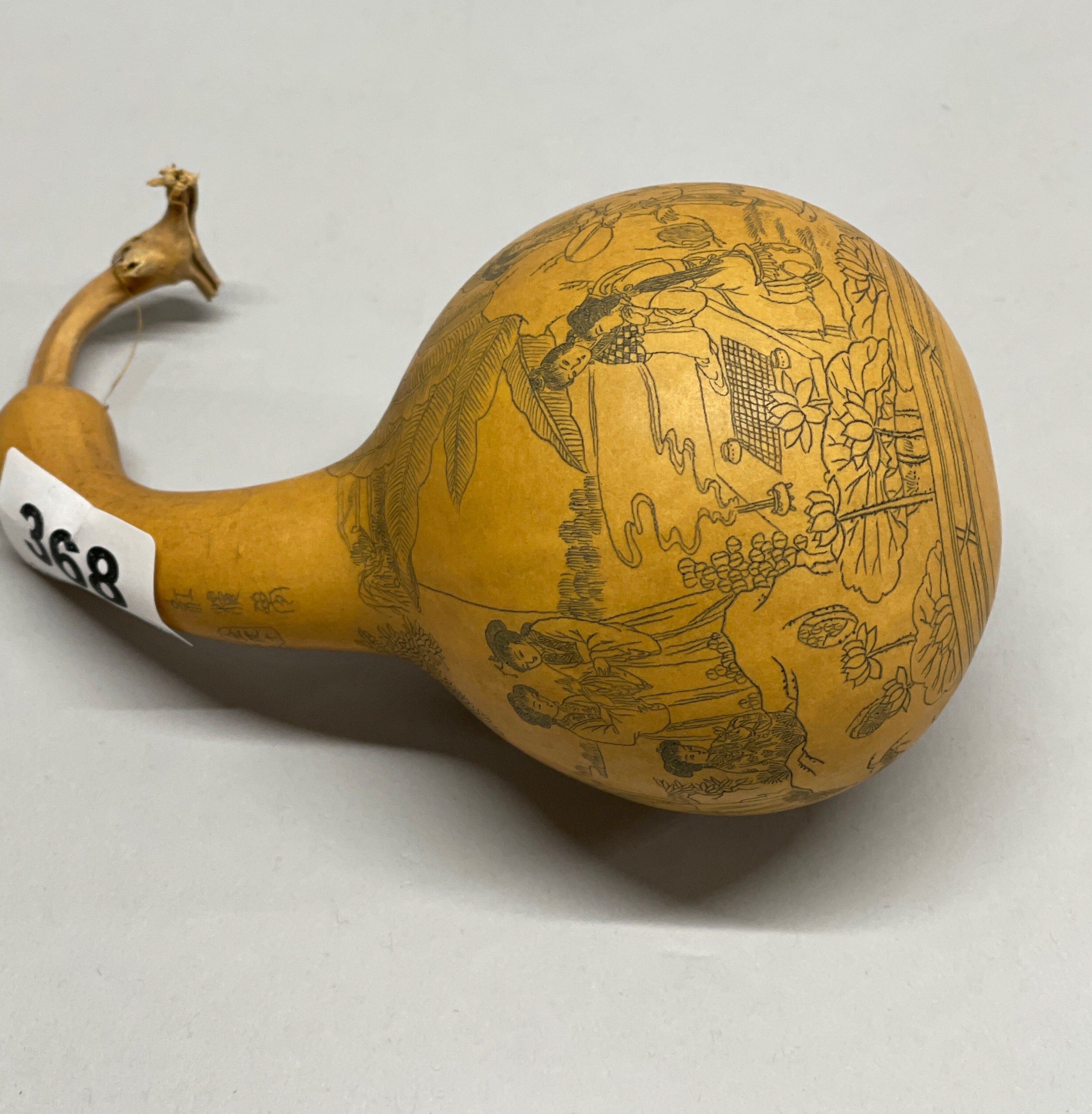 A Chinese hand engraved inked and signed gourd, H. 13cm.