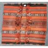 A handwoven Eastern saddle rug, 76 x 69cm.