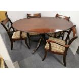 A small Regency style mahogany pedestal dining table with a set of four brass inlaid chairs, table