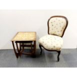 A 1970's teak tile topped side table with a further nest table beneath, together with an upholstered