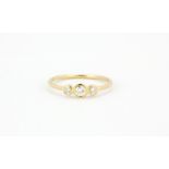 A 18ct yellow gold ring set with three round brilliant cut diamonds, (O.5).