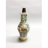 A 19th century Chinese Canton enamelled porcelain vase mounted on a wooden base as a table lamp,