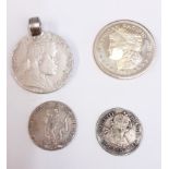 Four silver coins: an American One Troy Ounce, an Ethiopian Menelik II birr coin (mounted as