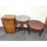 A leather topped mahogany drum table, together with a bedside cabinet and circular coffee table.