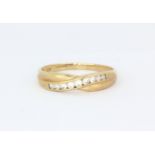 A hallmarked 9ct yellow gold ring set with white stones, (V.5).