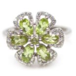 A 925 silver cluster ring set with oval cut peridots and white stones, (N.5).