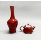 A Chinese Sang de Boeuf glazed porcelain vase, H. 24cm, together with a similar teapot.