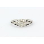 An antique white metal (tested minimum 9ct gold) ring set with old cut diamonds, (H.5).